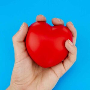 Pelota anti estres en forma de corazón en mano